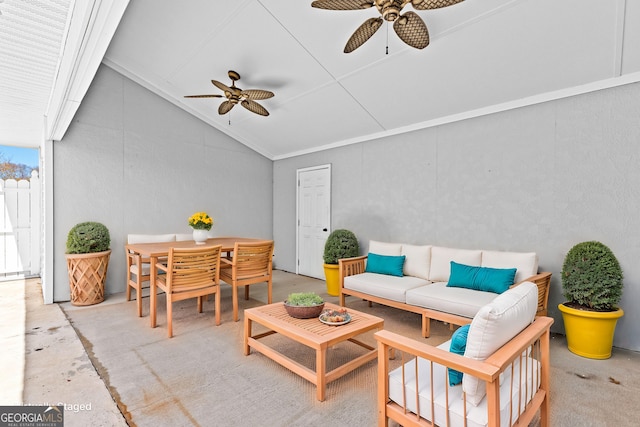 living area featuring vaulted ceiling and a ceiling fan