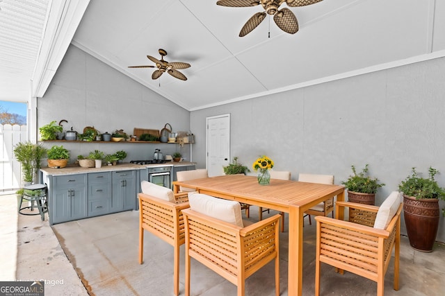 view of patio with exterior kitchen, outdoor dining area, and ceiling fan