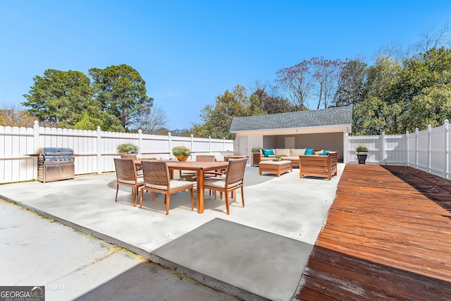 view of patio / terrace with an outdoor living space, a fenced backyard, area for grilling, and outdoor dining space