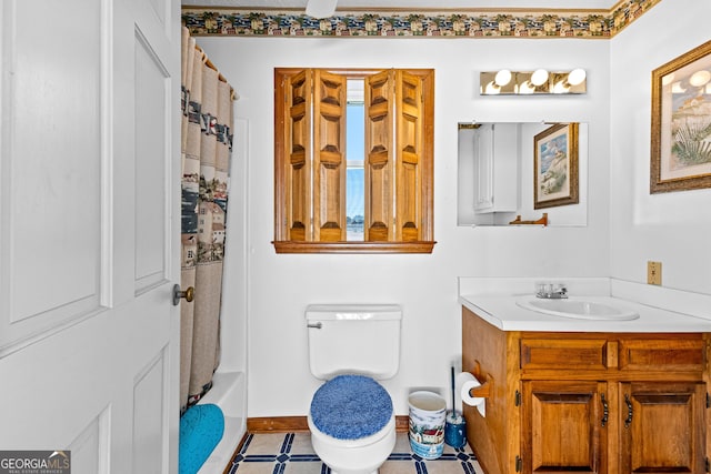 full bath with vanity, toilet, and baseboards