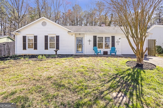 ranch-style house with driveway, fence, a front yard, an attached garage, and a chimney