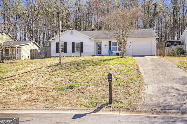 ranch-style home featuring concrete driveway, an attached garage, fence, and a front lawn