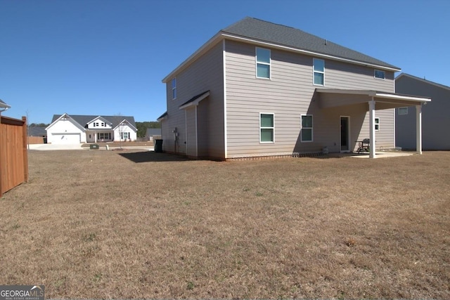 back of property with a lawn