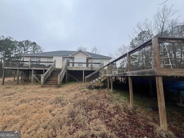 exterior space featuring stairs, a deck, and a sunroom