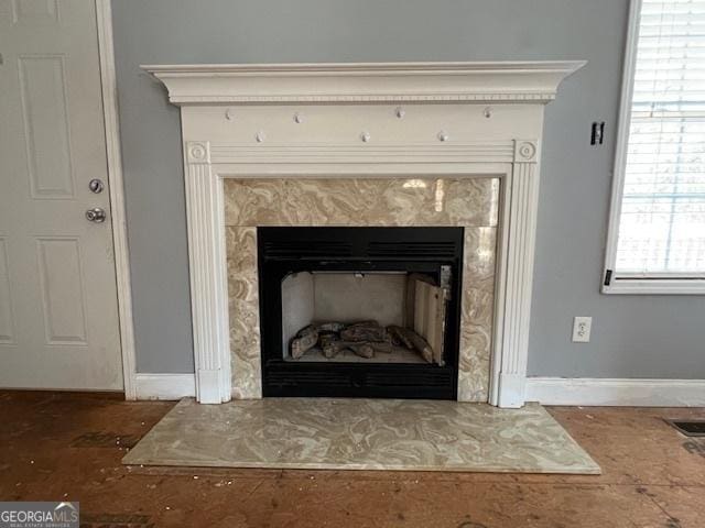 details with a fireplace, visible vents, and baseboards