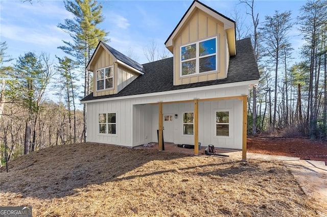 view of front of house with roof with shingles and board and batten siding