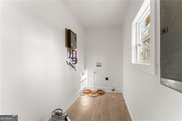 laundry area featuring hookup for a washing machine, wood finished floors, baseboards, hookup for an electric dryer, and laundry area