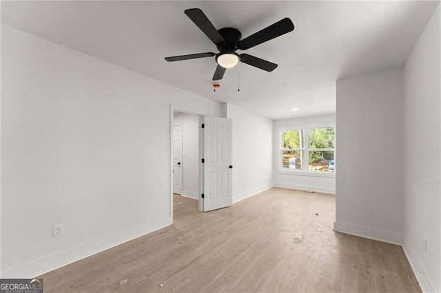 empty room with baseboards and wood finished floors