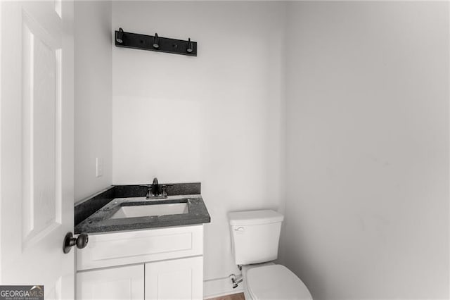 bathroom with toilet and vanity