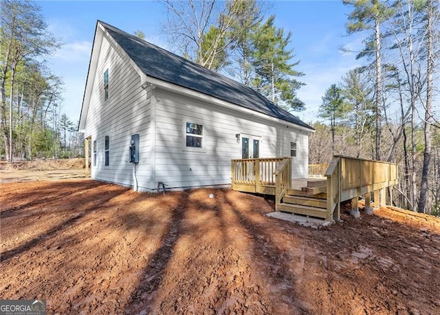 back of house featuring a deck and french doors