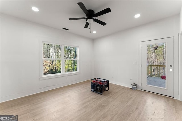 empty room with recessed lighting, baseboards, and wood finished floors