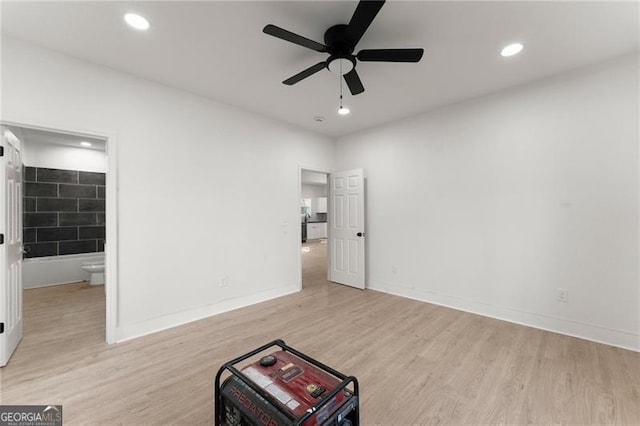 unfurnished bedroom featuring recessed lighting, baseboards, wood finished floors, and ensuite bathroom