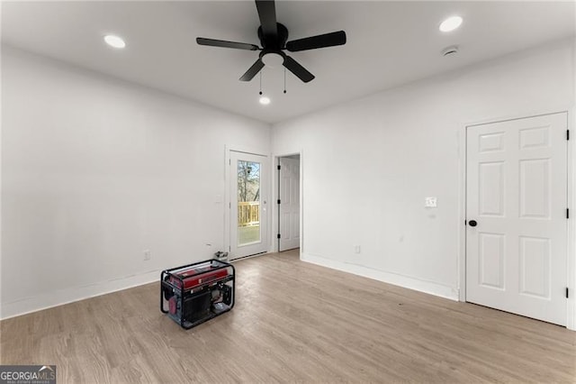 spare room with recessed lighting, baseboards, and wood finished floors