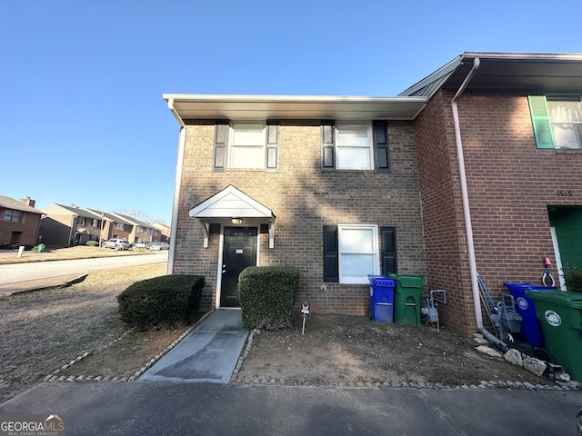 view of property featuring brick siding