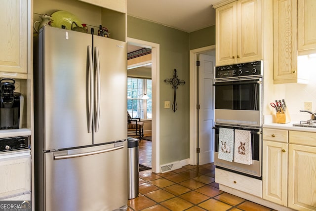 kitchen with baseboards, freestanding refrigerator, light countertops, double oven, and tile patterned floors