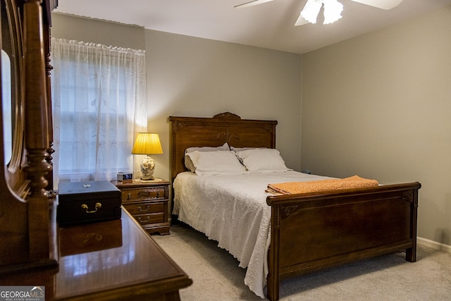 carpeted bedroom with baseboards and ceiling fan