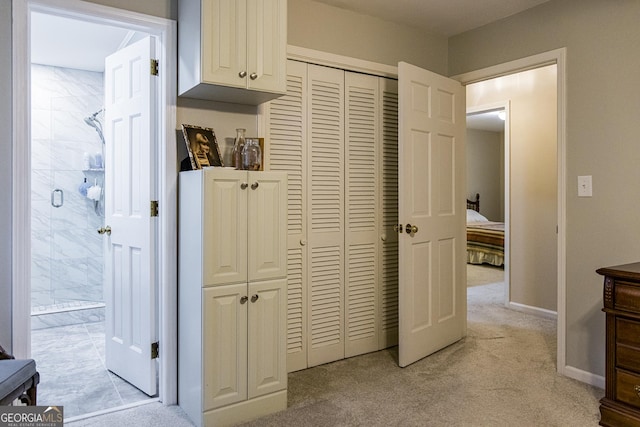 hall with baseboards and light carpet