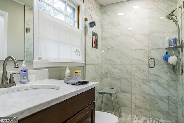 full bathroom with a shower stall, vanity, and toilet