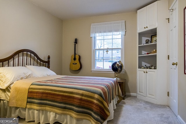 bedroom featuring baseboards and light colored carpet