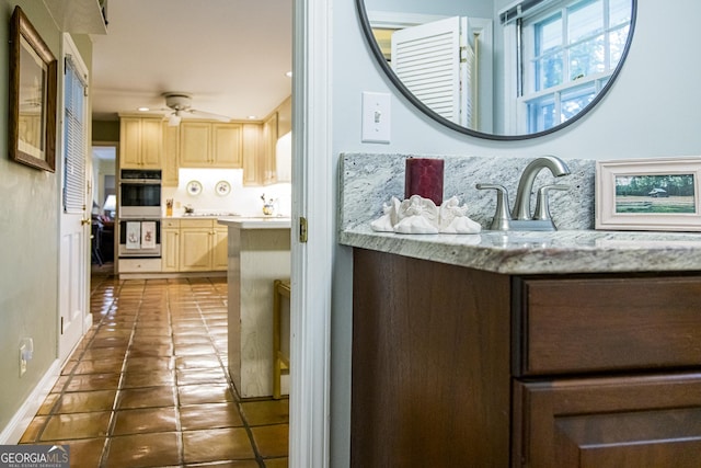 bathroom with ceiling fan, vanity, and tile patterned flooring