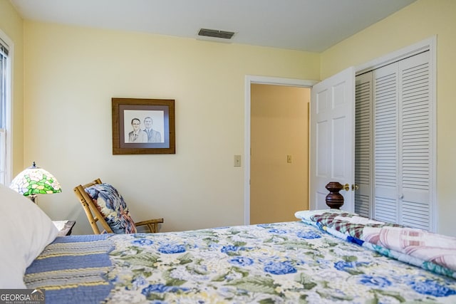 bedroom featuring visible vents and a closet