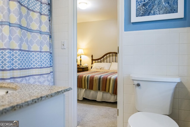 bedroom with carpet and tile walls