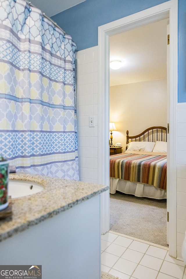 unfurnished bedroom featuring a sink, light tile patterned floors, and light carpet