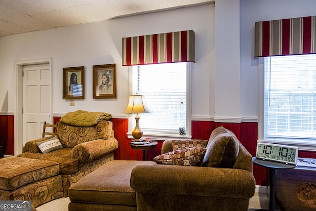 living area featuring a wainscoted wall