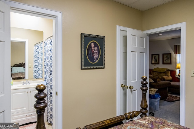 hall featuring carpet and a sink