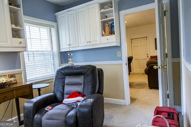 sitting room with a wealth of natural light, carpet flooring, baseboards, and a drop ceiling