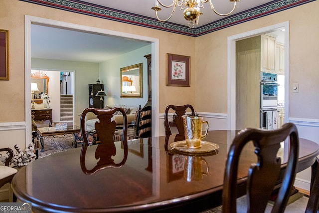 dining space with stairway and a notable chandelier