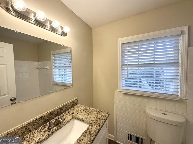 bathroom with visible vents, toilet, and vanity