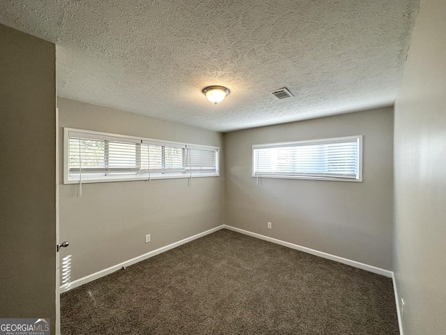3395 Longleaf Dr, Decatur, GA 30032 - unfurnished room with visible vents, baseboards, a textured ceiling, and dark carpet