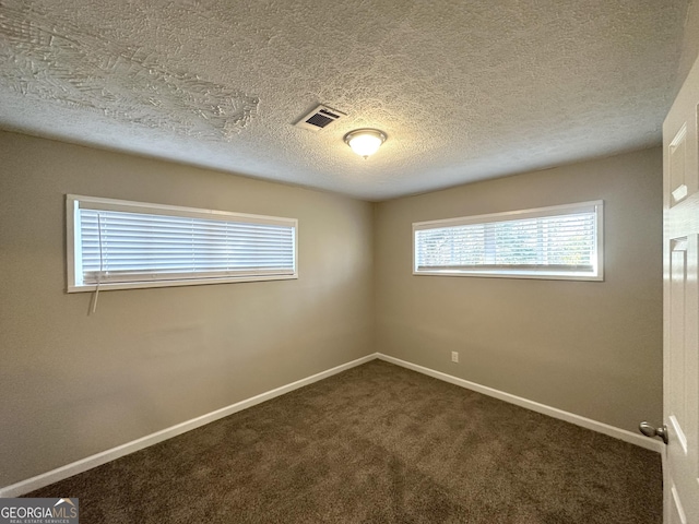 3395 Longleaf Dr, Decatur, GA 30032 - spare room with visible vents, baseboards, a textured ceiling, and dark carpet