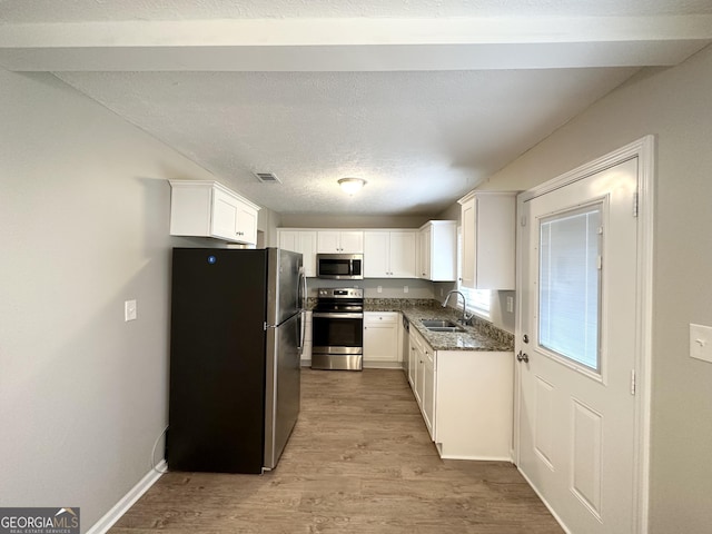 3395 Longleaf Dr, Decatur, GA 30032 - kitchen featuring visible vents, a sink, wood finished floors, stainless steel appliances, and white cabinets