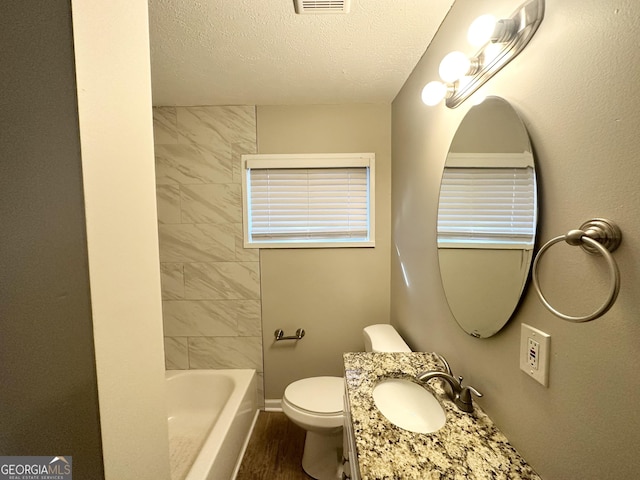 3395 Longleaf Dr, Decatur, GA 30032 - bathroom with visible vents, toilet, a textured ceiling, wood finished floors, and vanity