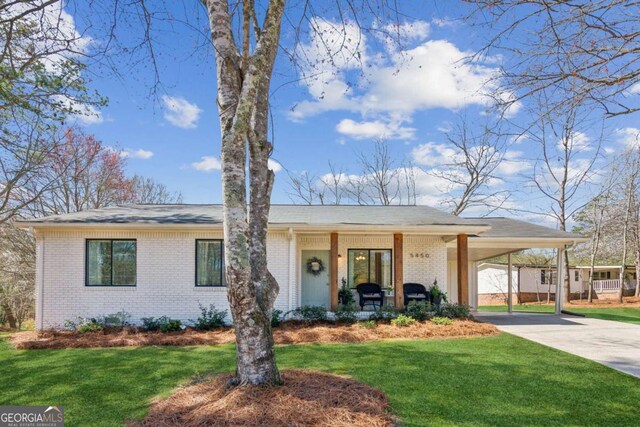 5450 Frazer Rd, Buford, GA 30518 - view of front of property with a porch, concrete driveway, a carport, a front lawn, and brick siding