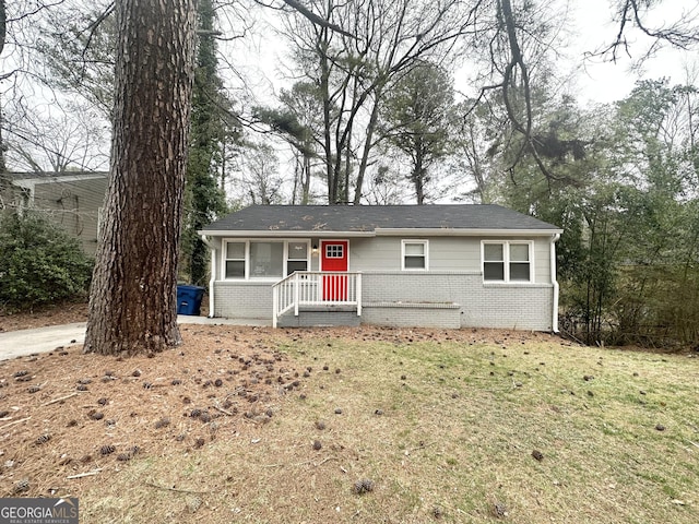 single story home with brick siding and a front yard