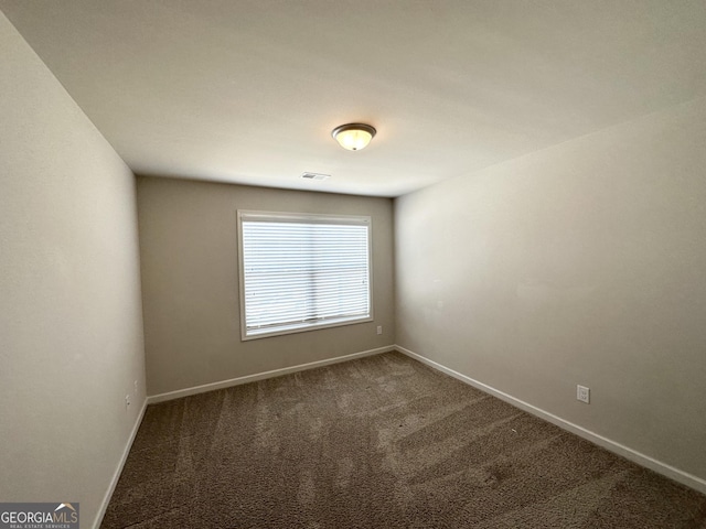 unfurnished room featuring visible vents, baseboards, and carpet floors
