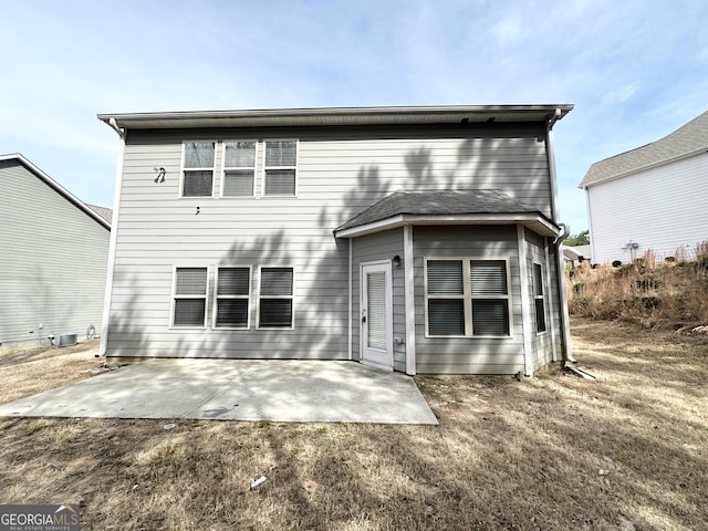 rear view of property with central AC unit and a patio area