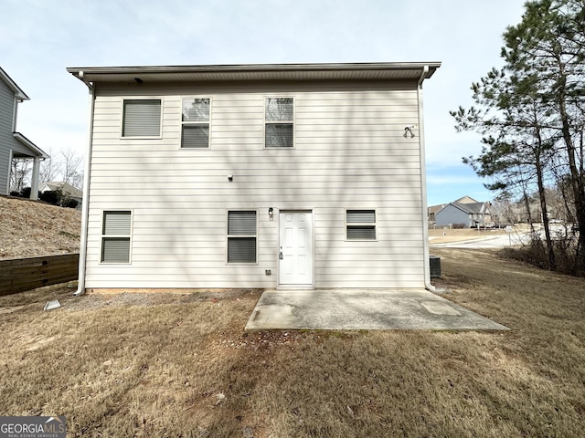 back of property featuring a patio and a yard