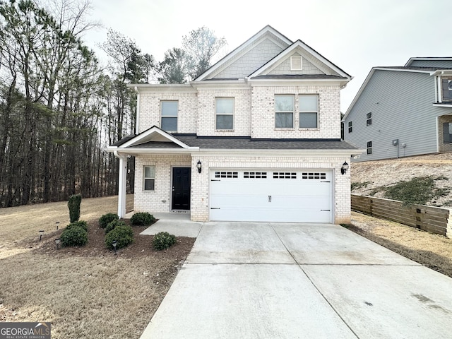 view of front of home featuring brick siding, concrete driveway, an attached garage, and fence