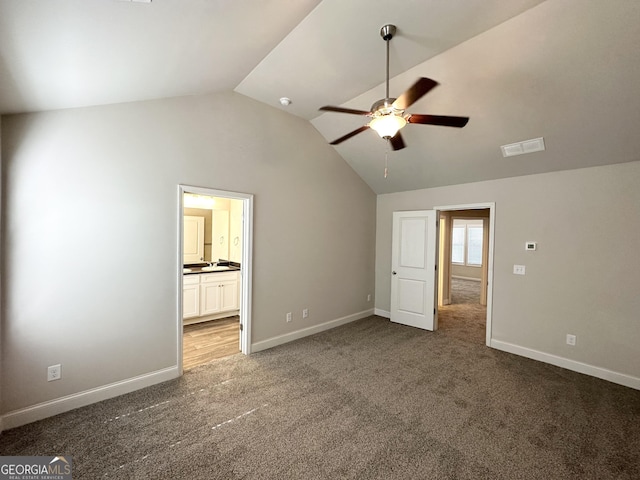 unfurnished bedroom featuring vaulted ceiling, carpet, visible vents, and baseboards