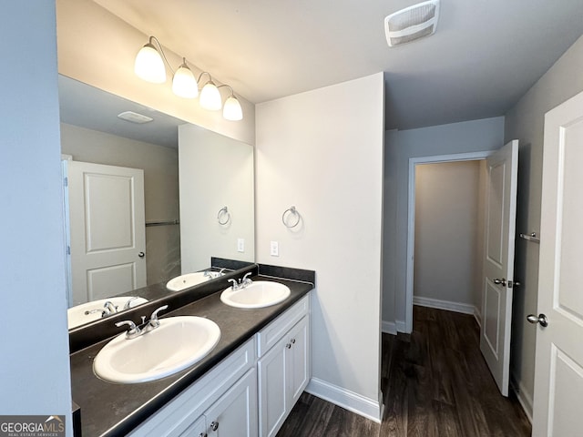 full bath with wood finished floors, visible vents, and a sink