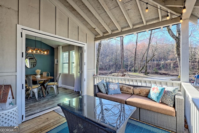 sunroom / solarium featuring lofted ceiling