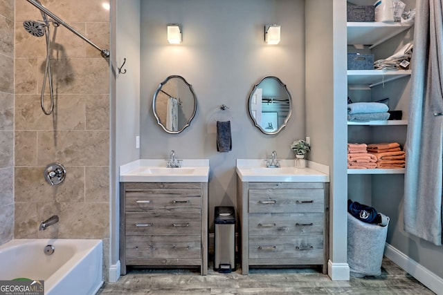 bathroom with baseboards, shower / tub combination, and vanity