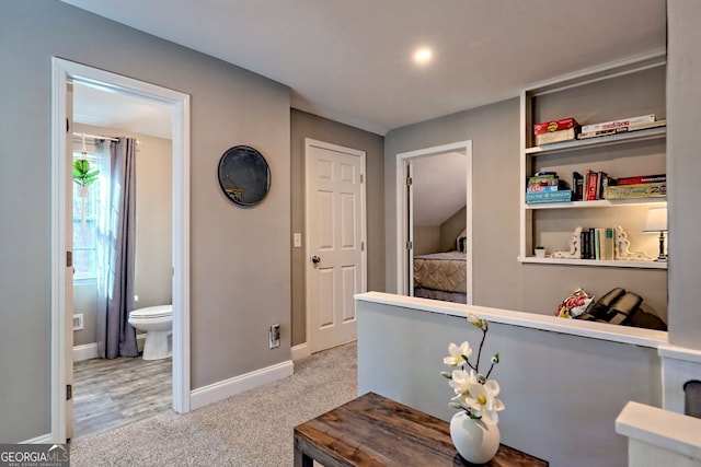 hall with carpet flooring and baseboards