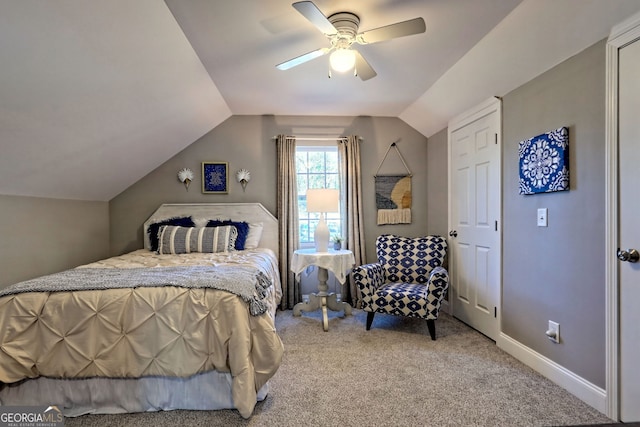 bedroom with vaulted ceiling, baseboards, carpet floors, and ceiling fan