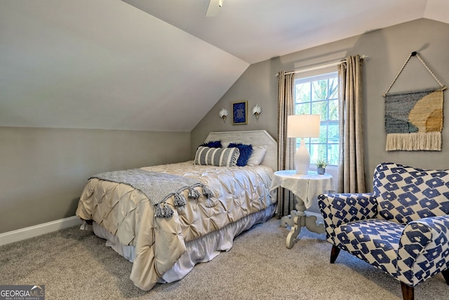 carpeted bedroom featuring vaulted ceiling, baseboards, and ceiling fan