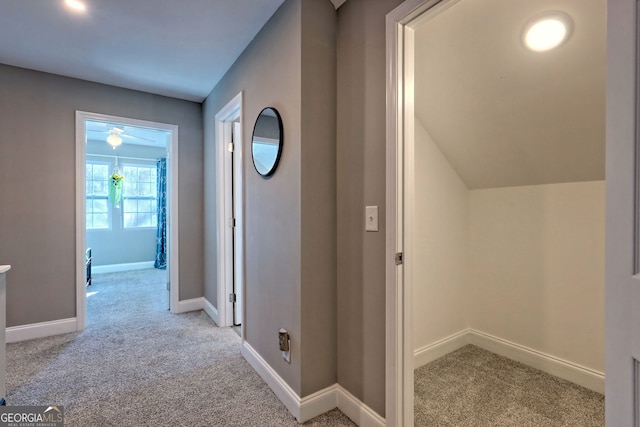 hallway with baseboards and carpet floors